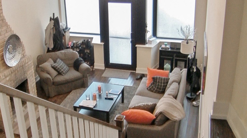 a living room with couches and a table in front of a window