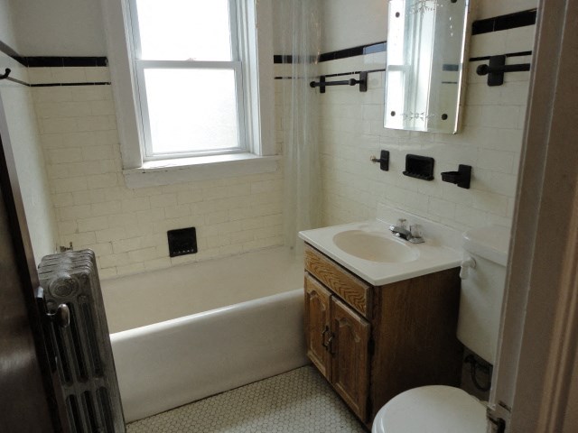 a bathroom with a sink and a toilet and a tub