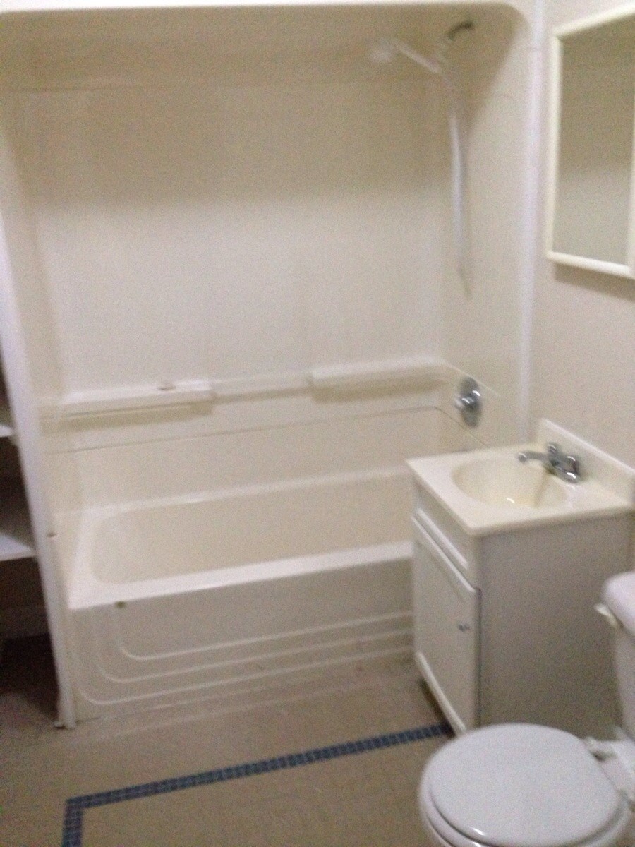 a bathroom with a sink toilet and a bath tub