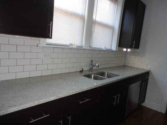 an empty kitchen with a sink and a window