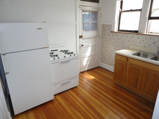 a kitchen with a stove and a refrigerator and a sink