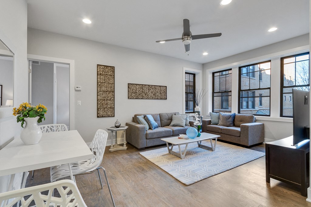 a living room with couches and a table and a tv