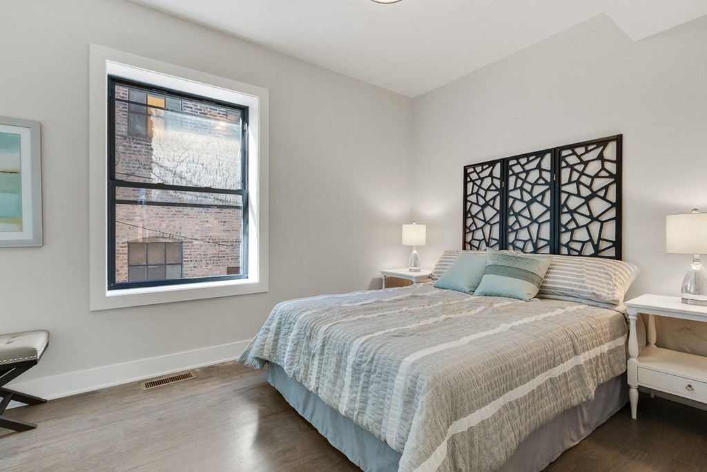 a bedroom with a bed and a window