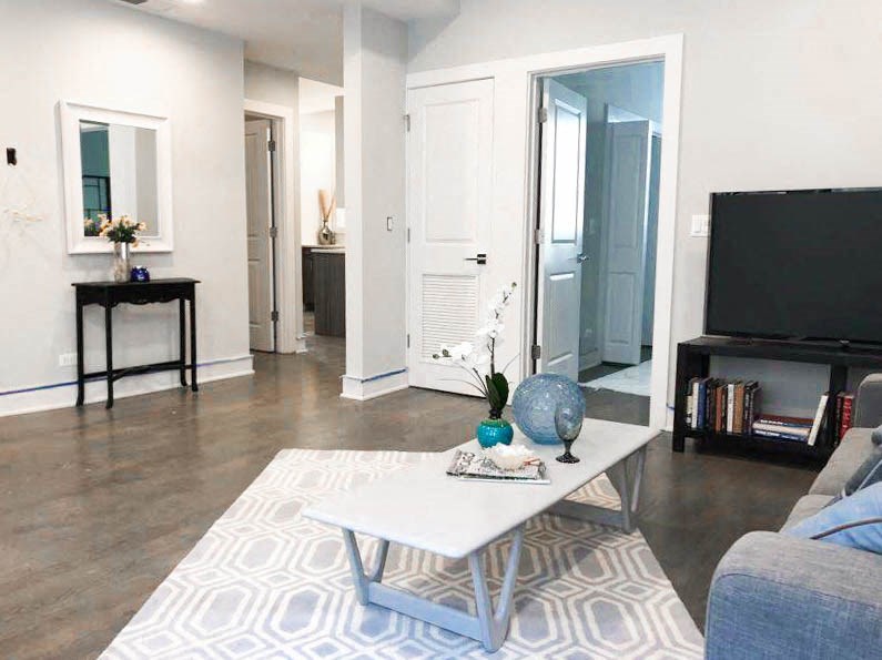 a living room with a table and a television