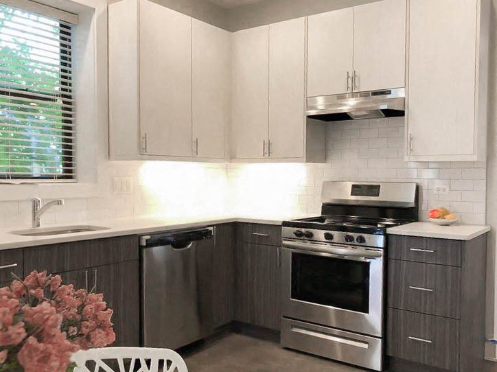 a kitchen with stainless steel appliances and white cabinets