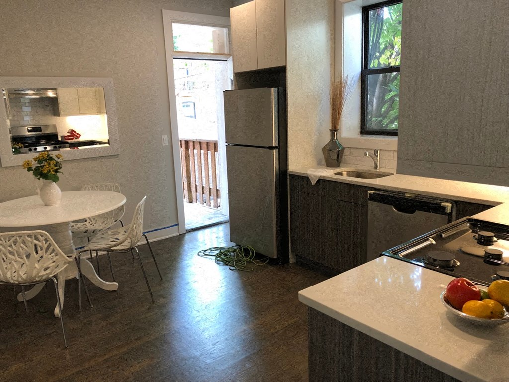 a kitchen with a white table and a refrigerator