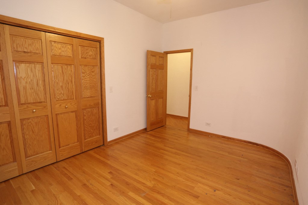 an empty room with wooden floors and a door