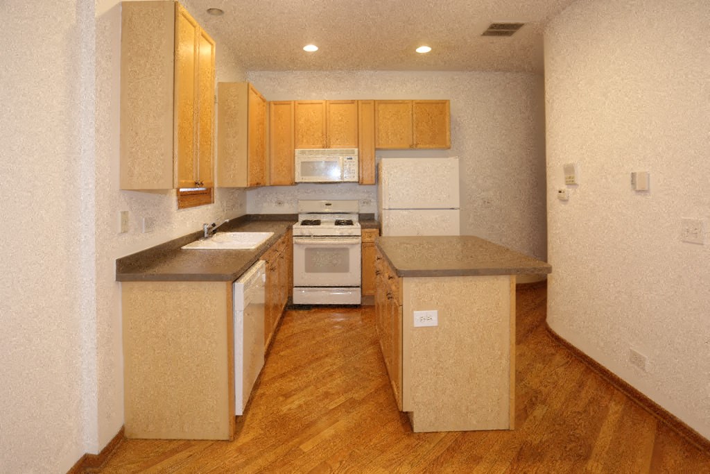 an empty kitchen with a stove and a sink