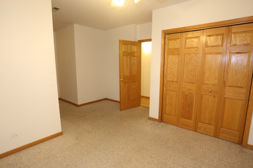 a bedroom with two closets and a door to a hallway
