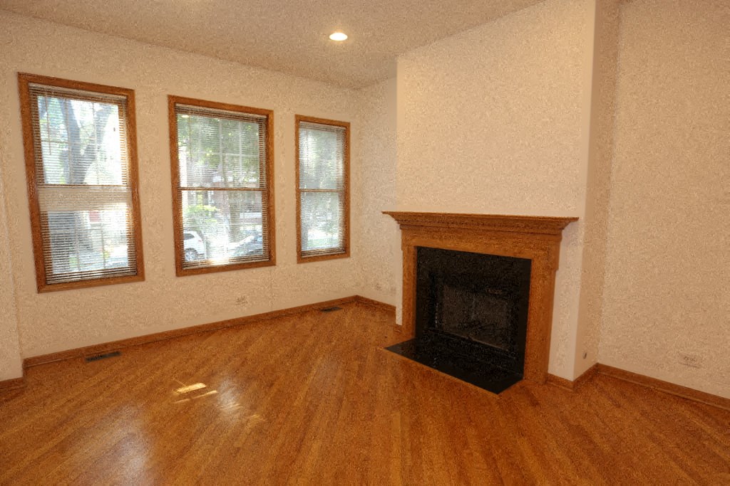 a living room with a fireplace and a wooden floor