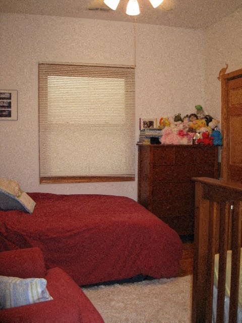 a bedroom with a bed and a dresser