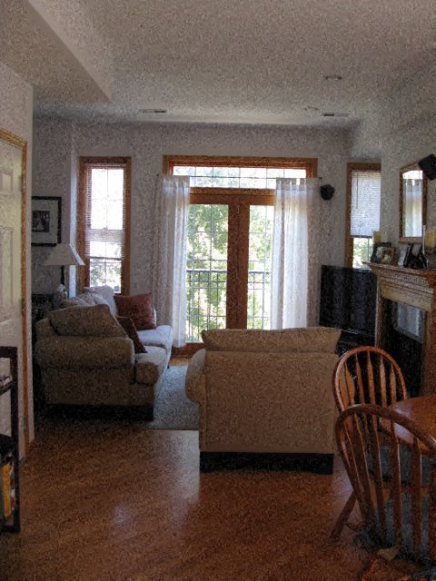 a living room with couches and chairs and a fireplace