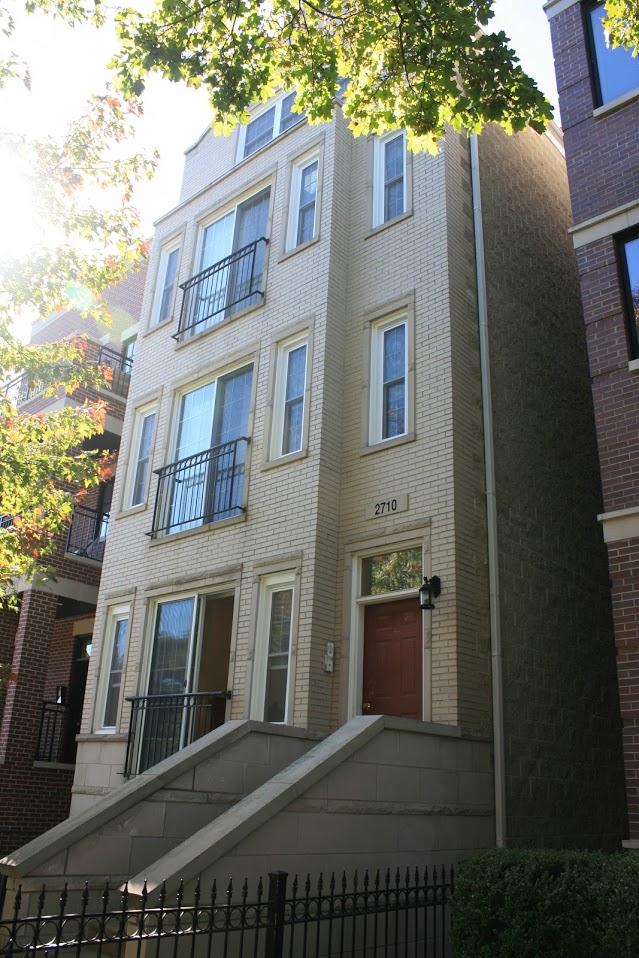 the front of a building with a red door and
