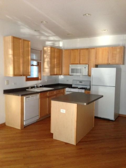 a kitchen with wooden cabinets and a white refrigerator