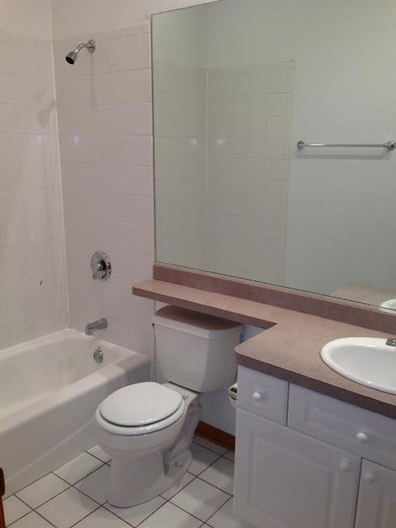 a white bathroom with a toilet and a sink