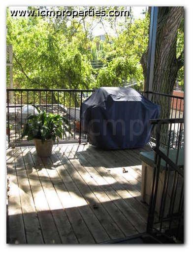 a screened in porch with a couch and a potted plant