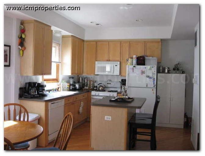 a kitchen with a table and a refrigerator