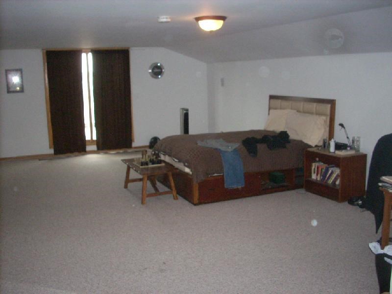 a living room with a bed and a table