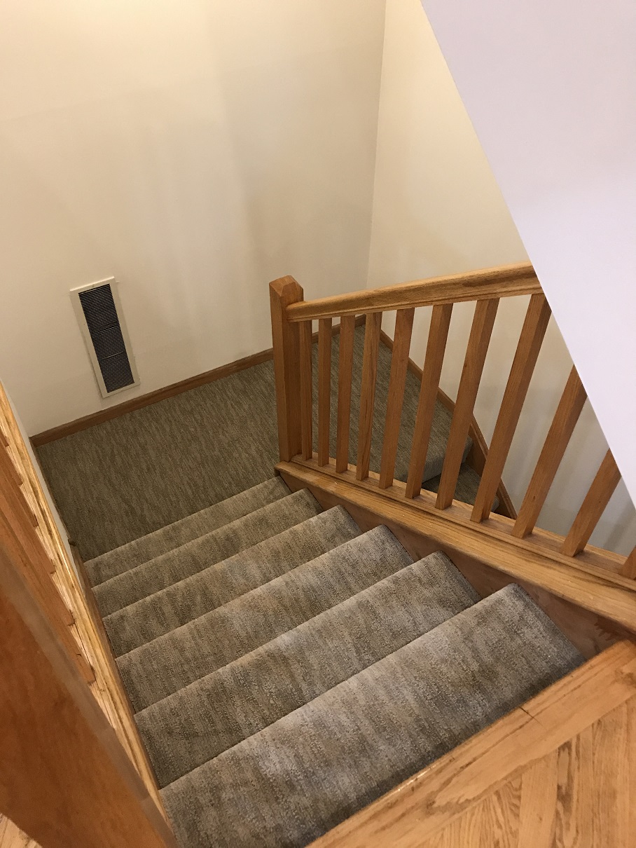 a view of the stairs from the third floor of a home