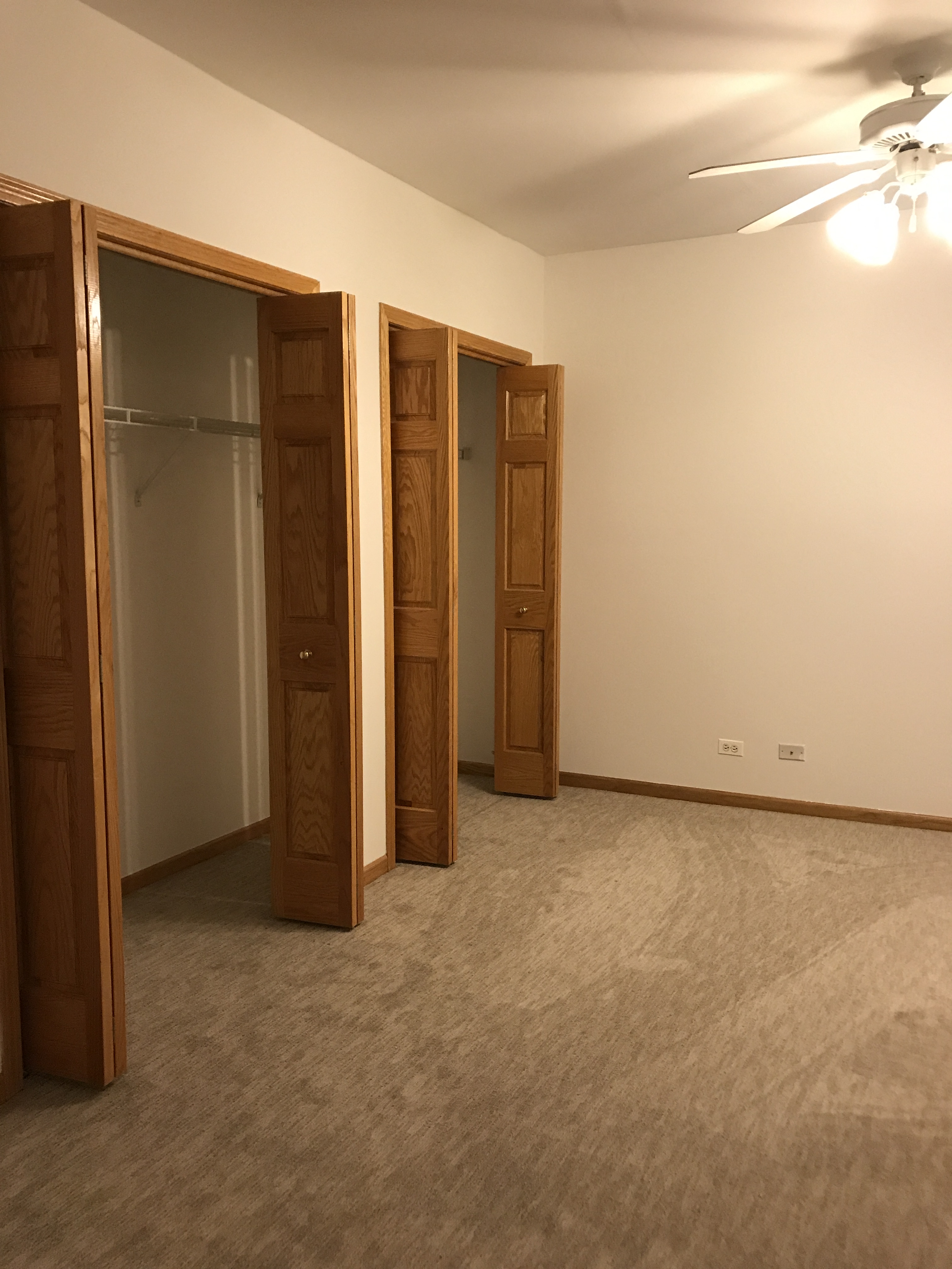 an empty room with three closet doors in it