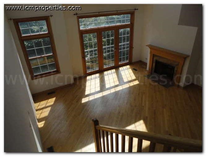 a view of a living room from the top of a staircase