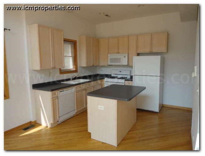 a kitchen with white appliances and black counter tops