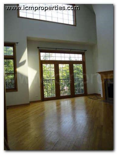 a living room with a hard wood floor and a window