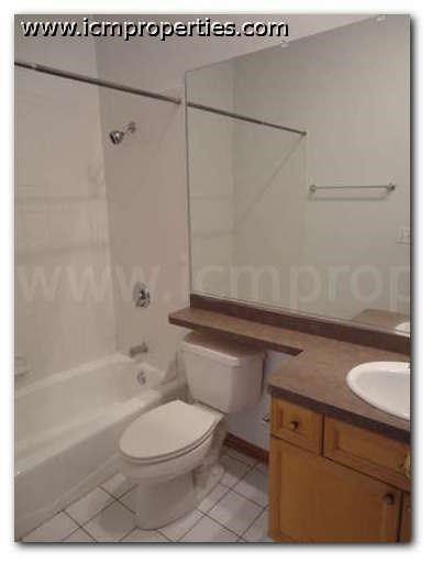 a bathroom with a toilet and a tub and a sink