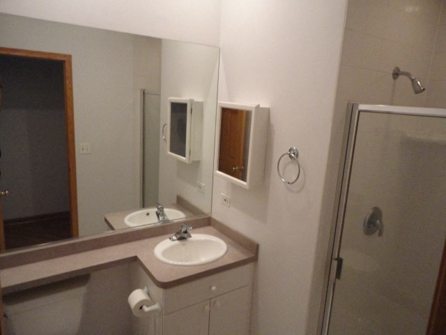 a small bathroom with a sink and a shower