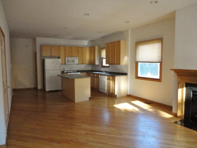 an empty kitchen with a stove and a refrigerator