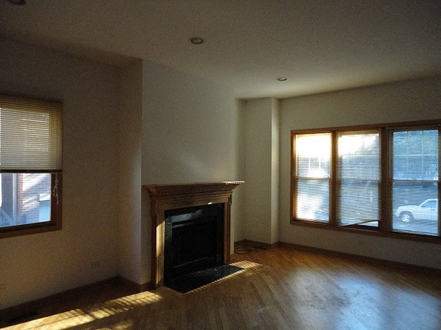 a living room with a fireplace and a window