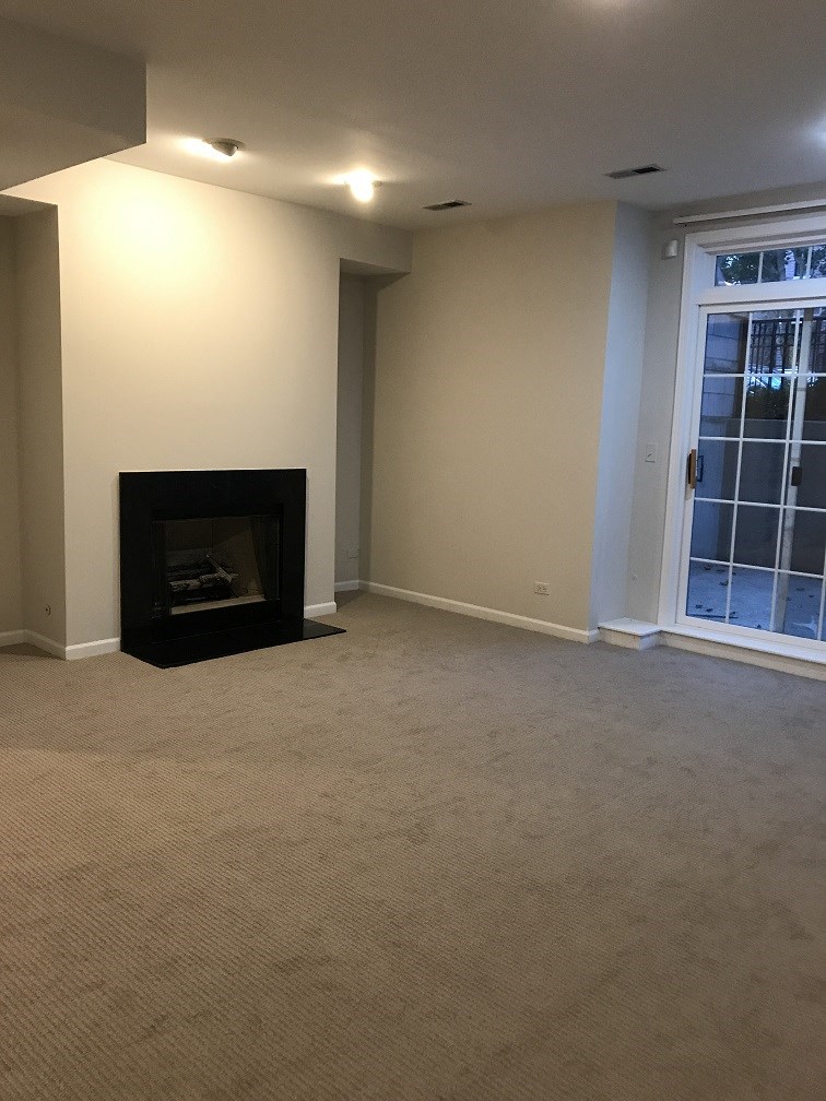 a living room with a fireplace and a window