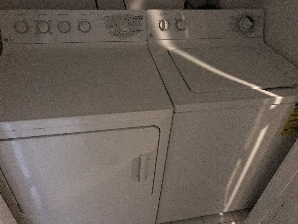 a close up of a white washer and dryer in a room