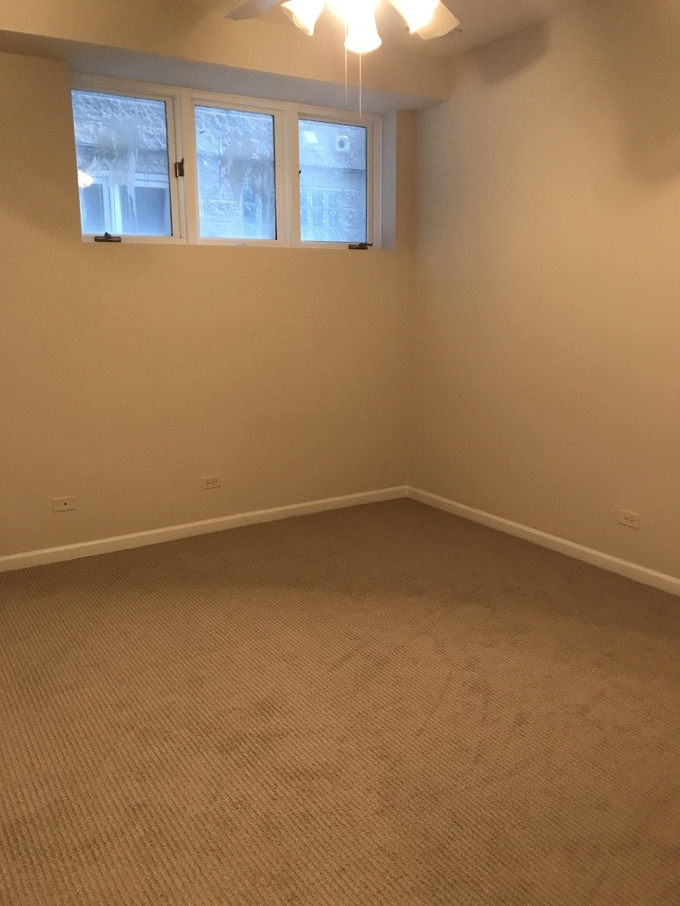 a room with a carpet and three windows