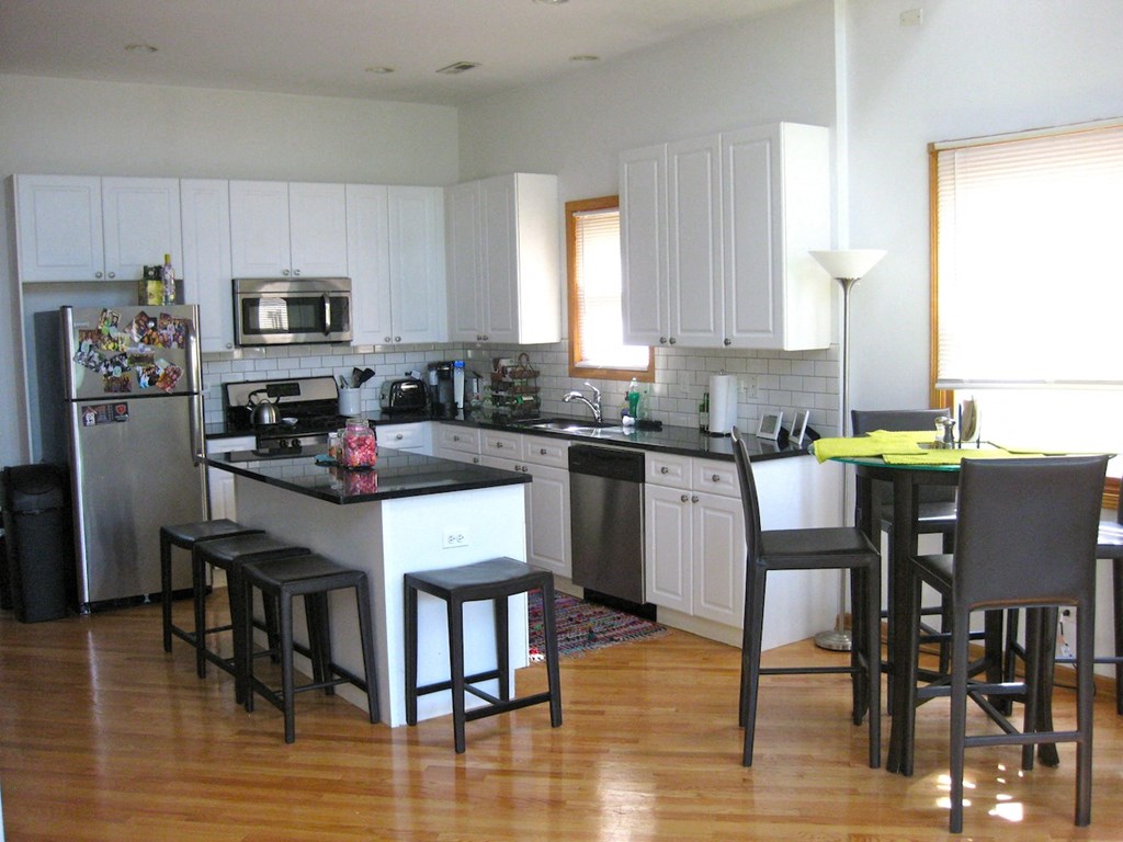 a kitchen with a center island and a stove top oven