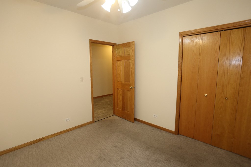 a bedroom with a closet and a door to a hallway