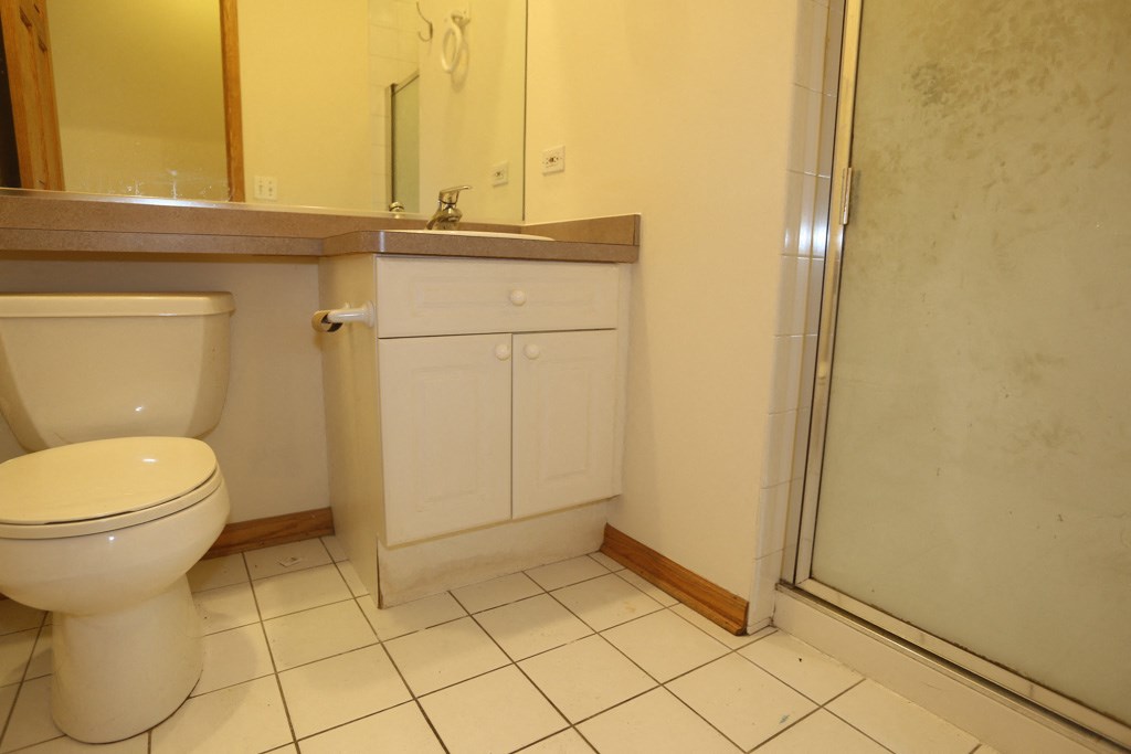 a bathroom with a toilet and a sink and a shower