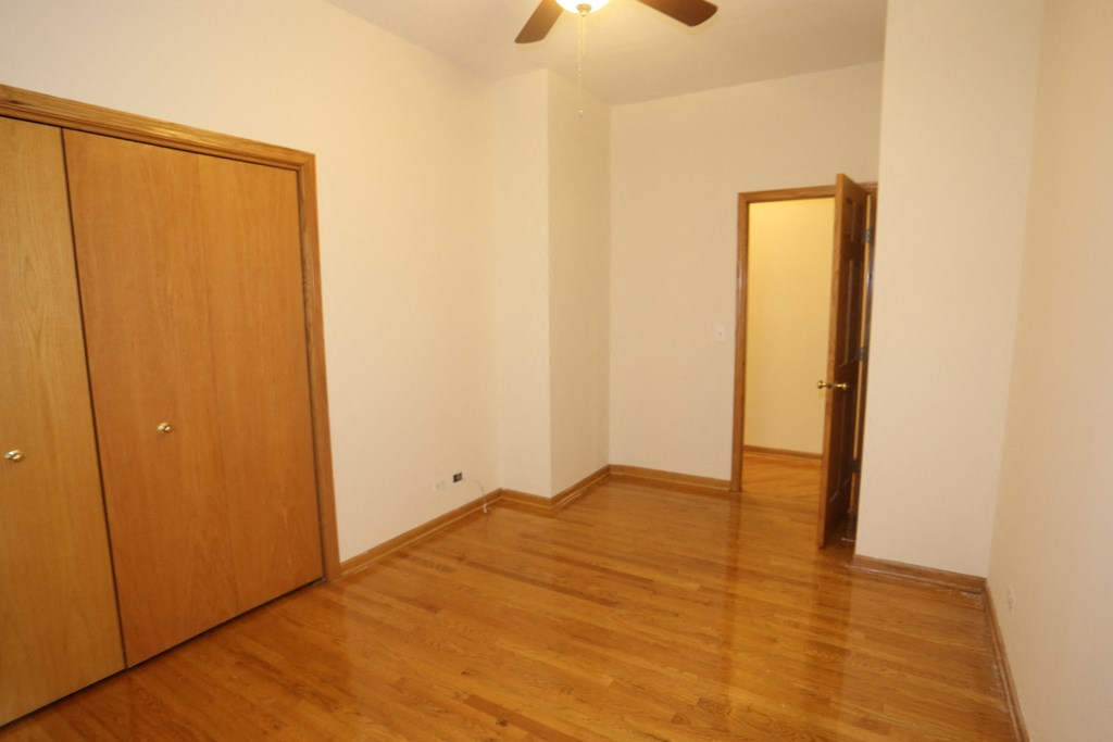 an empty living room with wooden floors and a door