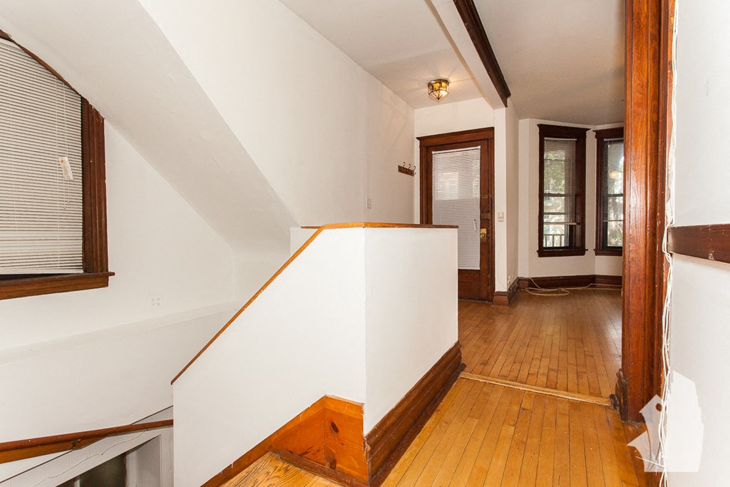 a view from the top of the stairs looking into the hallway and the living room