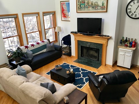 a living room with couches and a fireplace and a tv