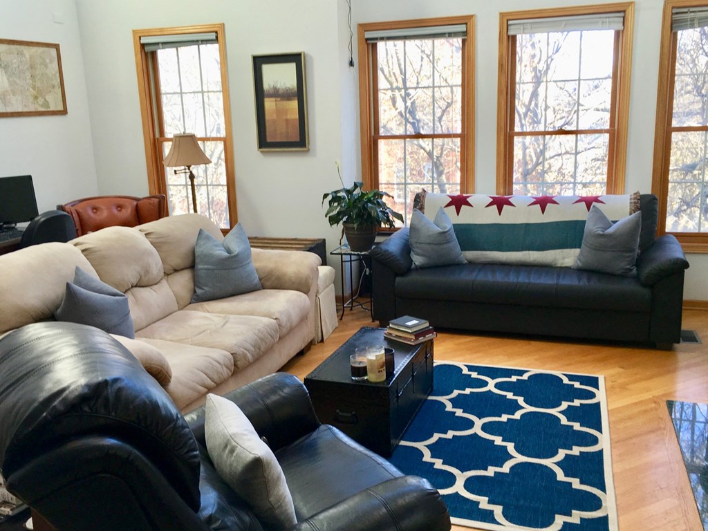 a living room with couches and chairs and a rug
