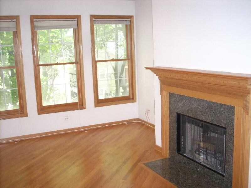 a living room with a fireplace and a wooden floor