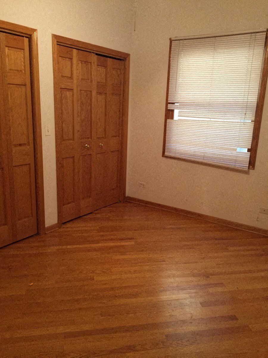 an empty room with a door and a window