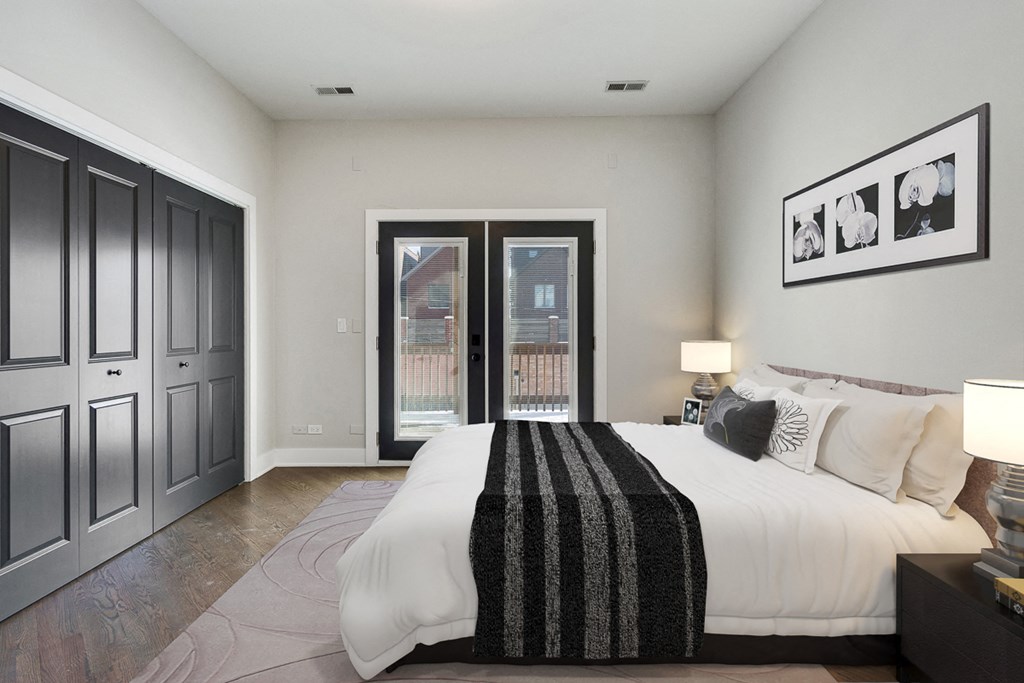 a bedroom with a large bed and a door to a balcony