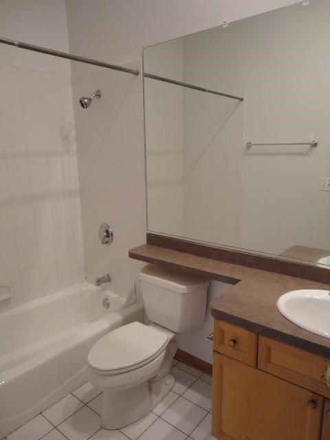 a white bathroom with a toilet and a sink
