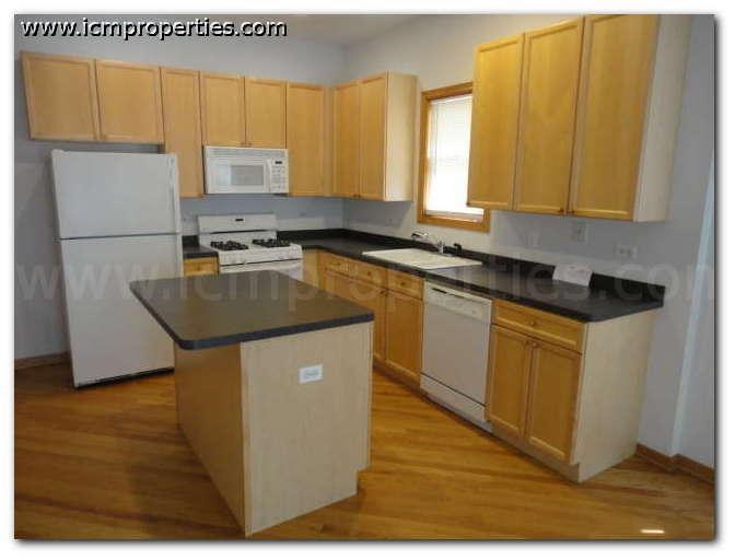 a kitchen with white appliances and wooden cabinets