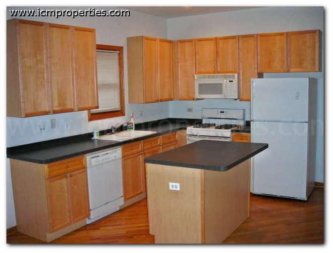 a kitchen with wooden cabinets and a white refrigerator