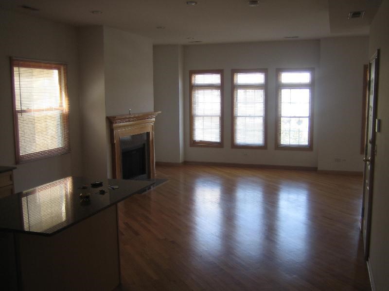 an empty living room with a fireplace and