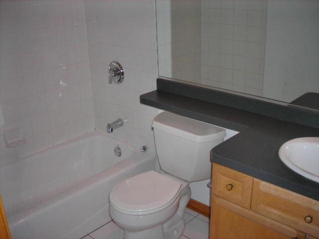 a bathroom with a toilet and a tub and a sink