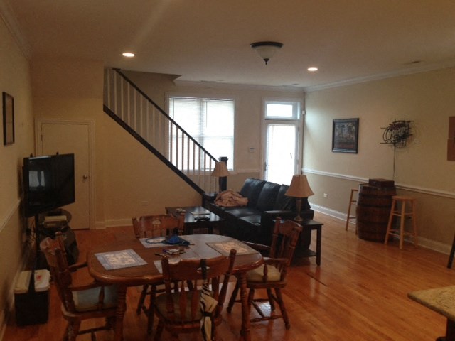 an empty living room with a dining room table and a couch